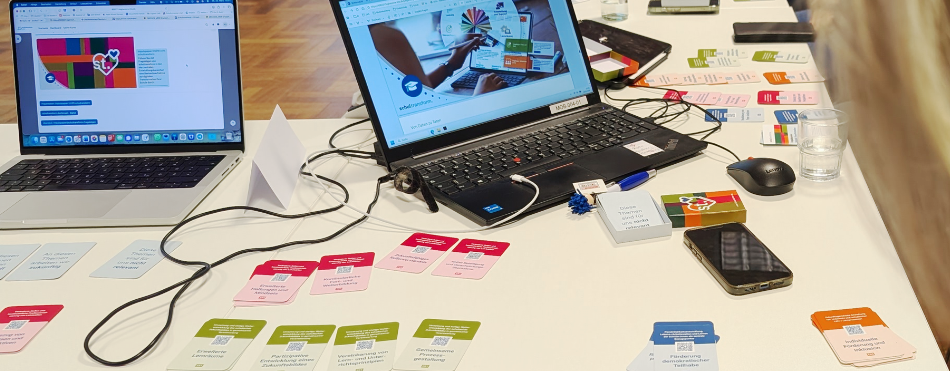 EiDie Plattform schultransform auf dem Laptop. Auf dem Tisch liegt ein ergänzendes analoges Kartenset.